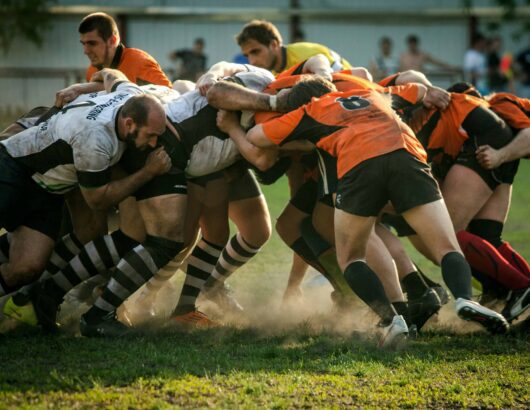 The image of the rugby game players on the field